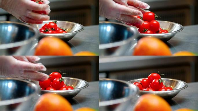 厨房厨师把干净的樱桃西红柿放在盘子里