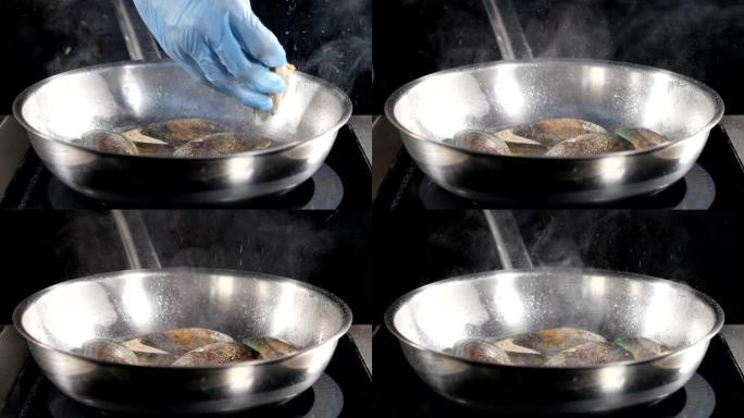 厨师烹饪海鲜。在不锈钢锅中准备海鲜的特写。慢动作。酱汁蔬菜贻贝。美味的食物视频。高清
