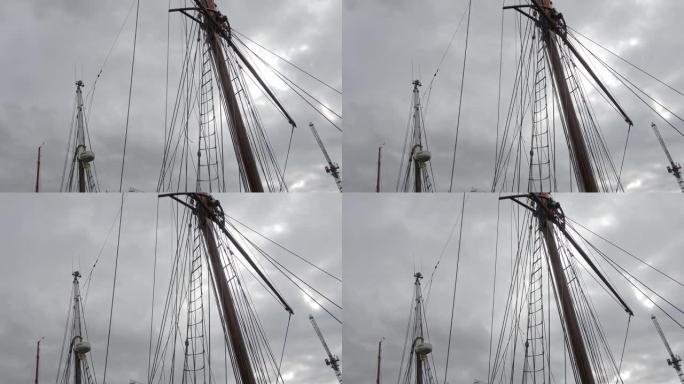 帆船桅杆在带有索具细节的帆船上抵御多云的天空