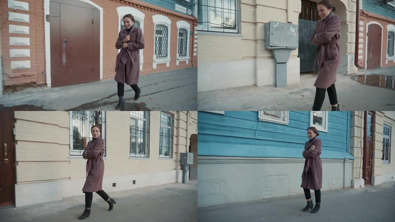 穿丁香大衣的女孩走在老城的街道上