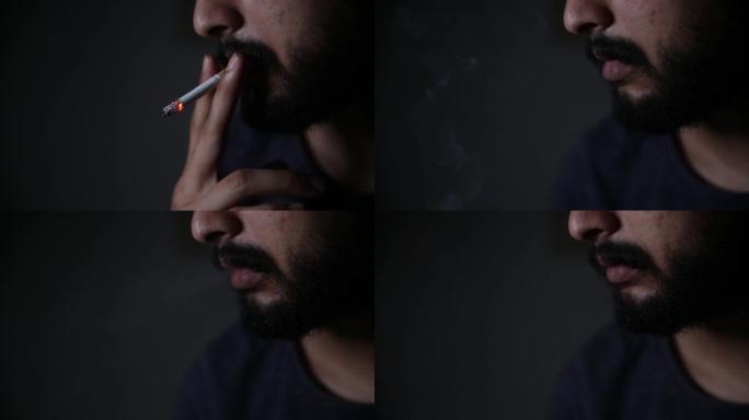 蓄着胡子的男人一边抽烟一边吐着烟