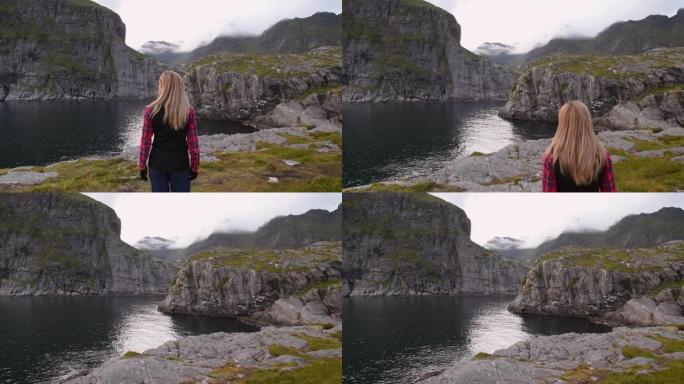 女人看着罗弗滕群岛的山脉。