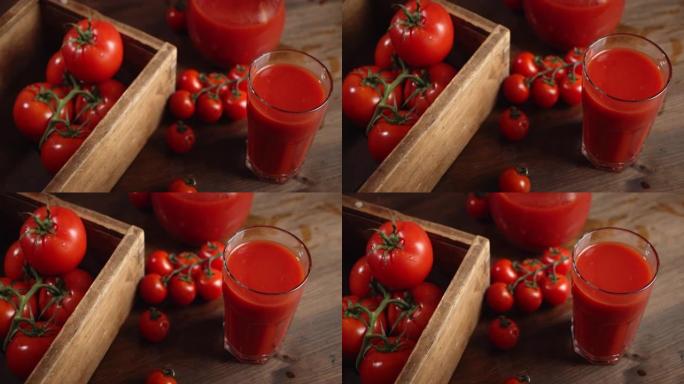 番茄汁和西红柿放在桌子上的木箱里。