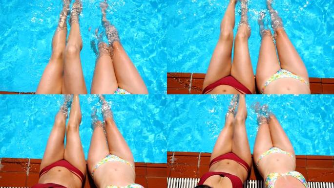 妇女在游泳池边缘晒日光浴，并在水中悬挂脚。双腿晒黑的女孩在盆子附近放松。穿着比基尼的女士们在度假胜地