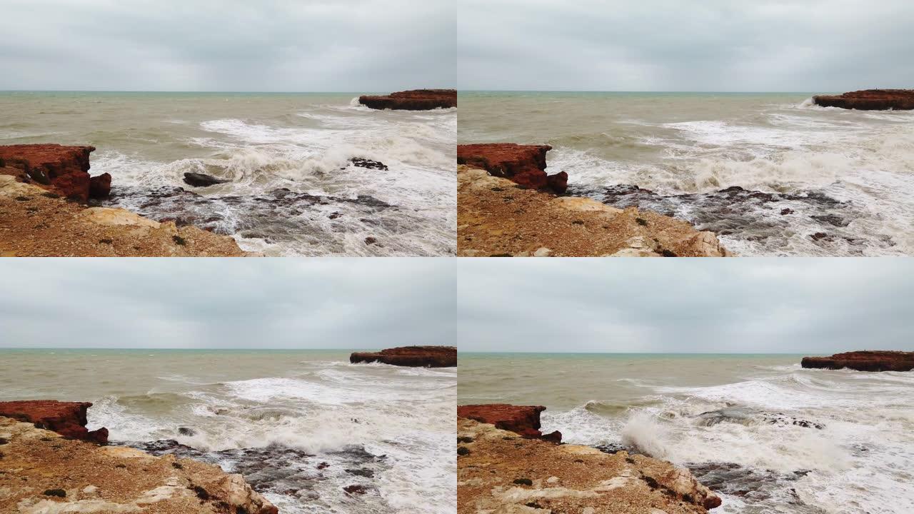 强风吹向岩石海岸的海浪