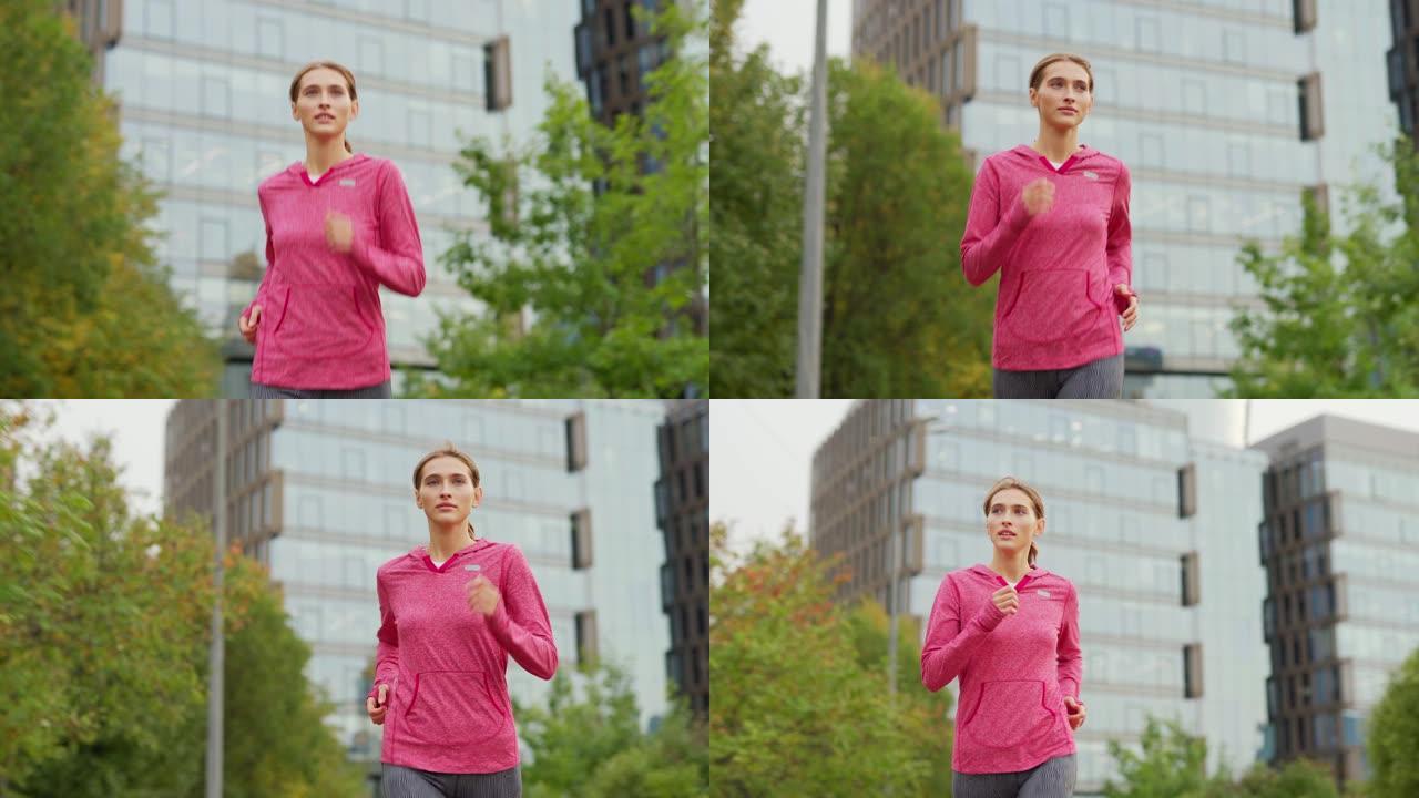 在日常慢跑锻炼中，运动年轻女子在城市街道上奔跑