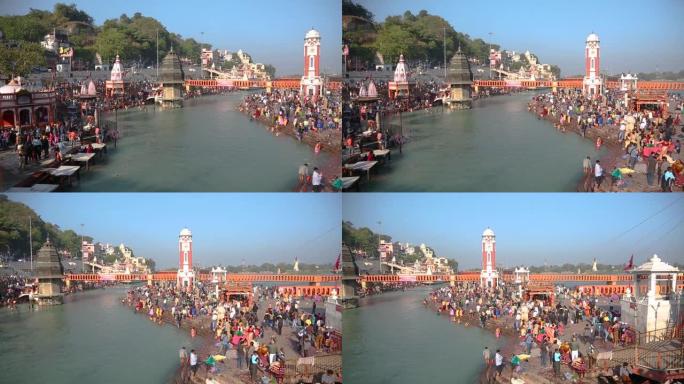 左图:印度北阿坎德邦的哈德瓦尔市，钟楼，朝圣者在圣河恒河上进行印度教仪式和祈祷。