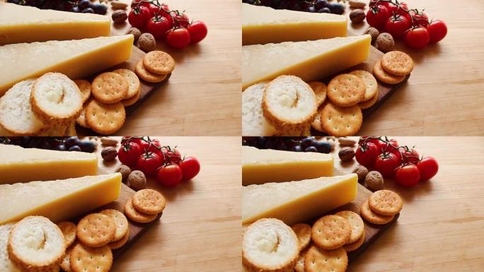 木制背景上的有机奶酪、水果、坚果奶酪拼盘。从上方观看。
