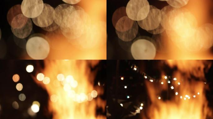 在大型营火中燃烧的火焰的特写镜头，背景为灯光