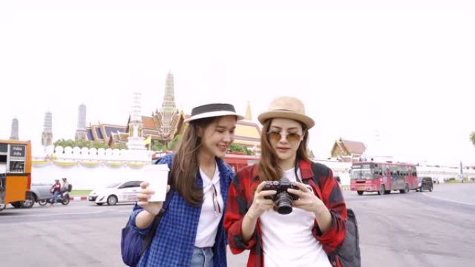 使用数码相机的女性博客作者将摄影和视频制作视频博客指南带到旅游景点，在泰国曼谷的 “什么Pho” 地