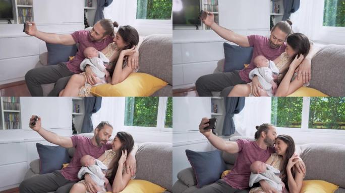 4k微笑的白人男子使用智能手机拍摄他的妻子和正在睡觉的新生儿子的家庭视频。父亲用爱亲吻母亲和可爱的婴