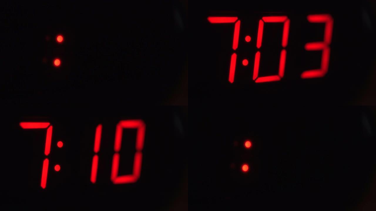黑色数字时钟屏幕的特写显示7.00。黑色背景上闪烁红色数字。现代定时器系统和霓虹灯、电动报警装置