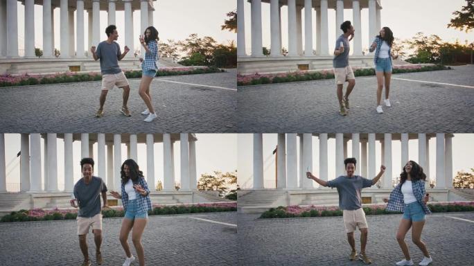 年轻的非洲裔美国夫妇在公园附近的公园里跳舞，他们拿着未使用的烟雾弹