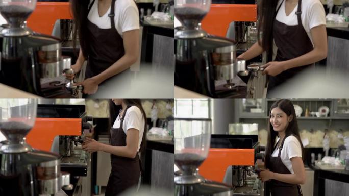 巴蒂斯塔美丽的年轻亚洲女子快乐地在咖啡店工作。她看着镜头，微笑着。