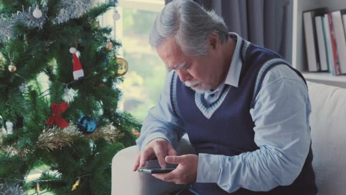 老年商人或老人，坐着并使用手机处理电子邮件或文本互联网