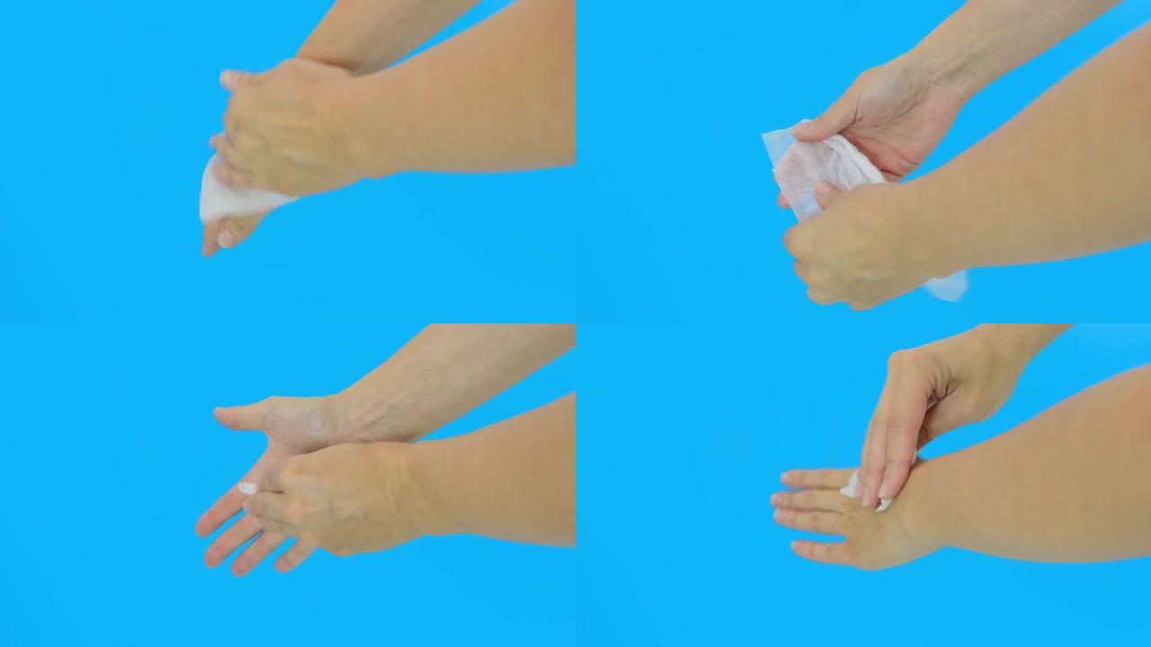 女人手使用湿洗抗菌湿巾，蓝色背景，卫生和身体护理概念