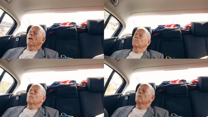 一位老人正坐在后座上睡觉