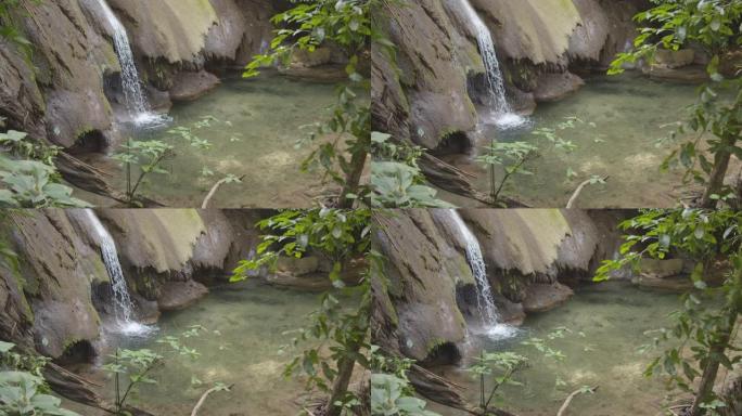 墨西哥帕伦克玛雅遗址旁的瀑布进入绿色野生森林的特写视图