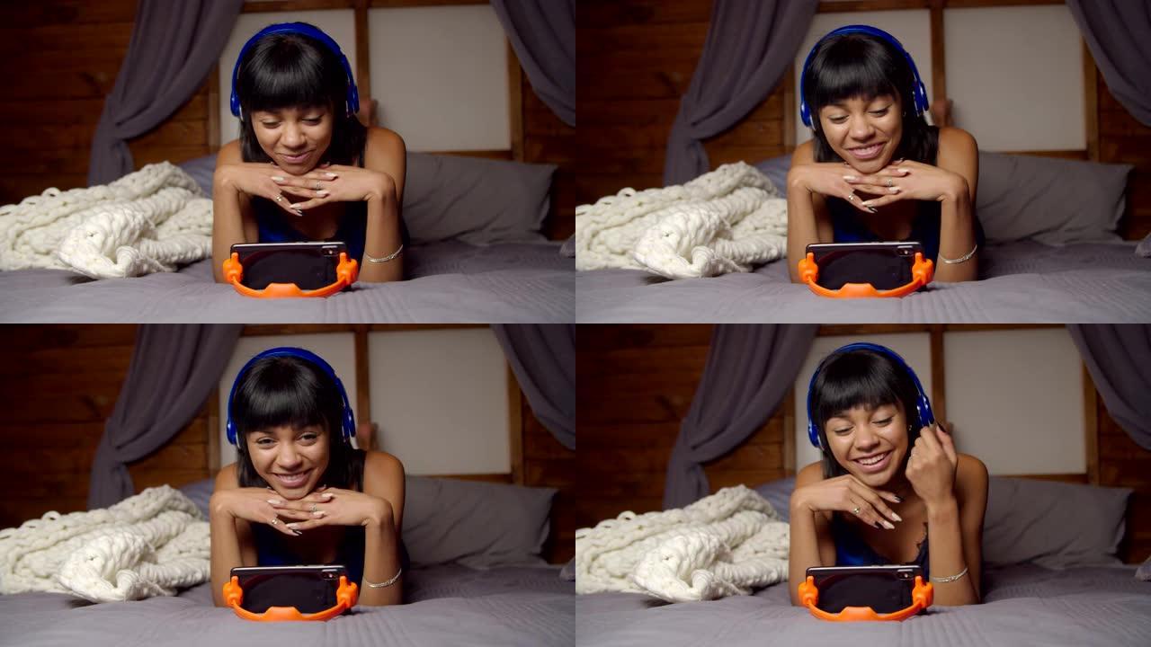 可爱的女人在床上的手机上在线流媒体视频