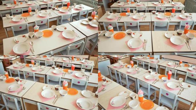 幼儿园里有盘子、杯子、叉子和勺子的餐桌。准备午休。表设置