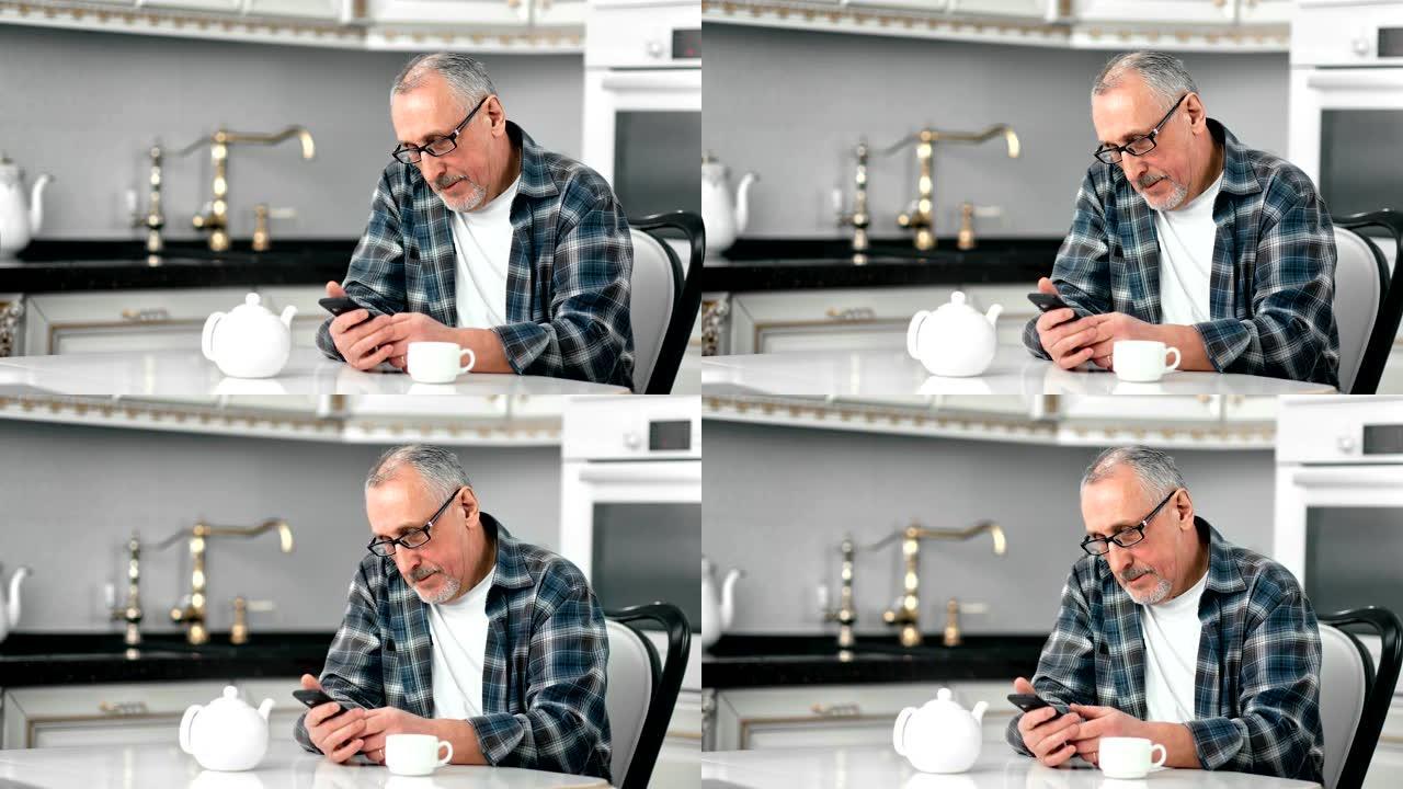 微笑着戴眼镜的成熟大胡子男人使用智能手机聊天享受咖啡休息
