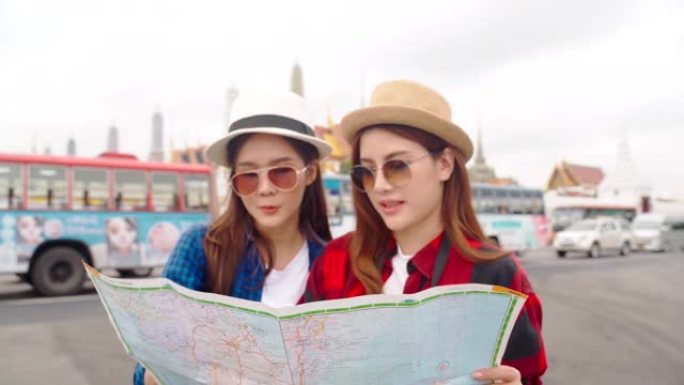 女人和朋友在看地图。亚洲女人喜欢在泰国唐人街旅行