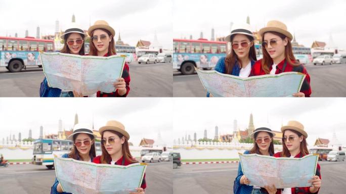 女人和朋友在看地图。亚洲女人喜欢在泰国唐人街旅行