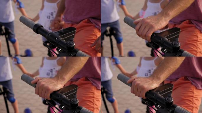 一名男子将手放在电动踏板车方向盘上的特写镜头