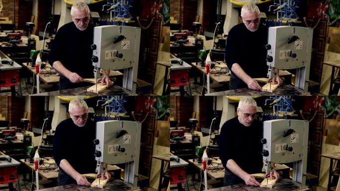 一个成年头发的男人在铣床上工作，同时在车间的一个工作室里雕刻木制图案的肖像。行动。木工行业