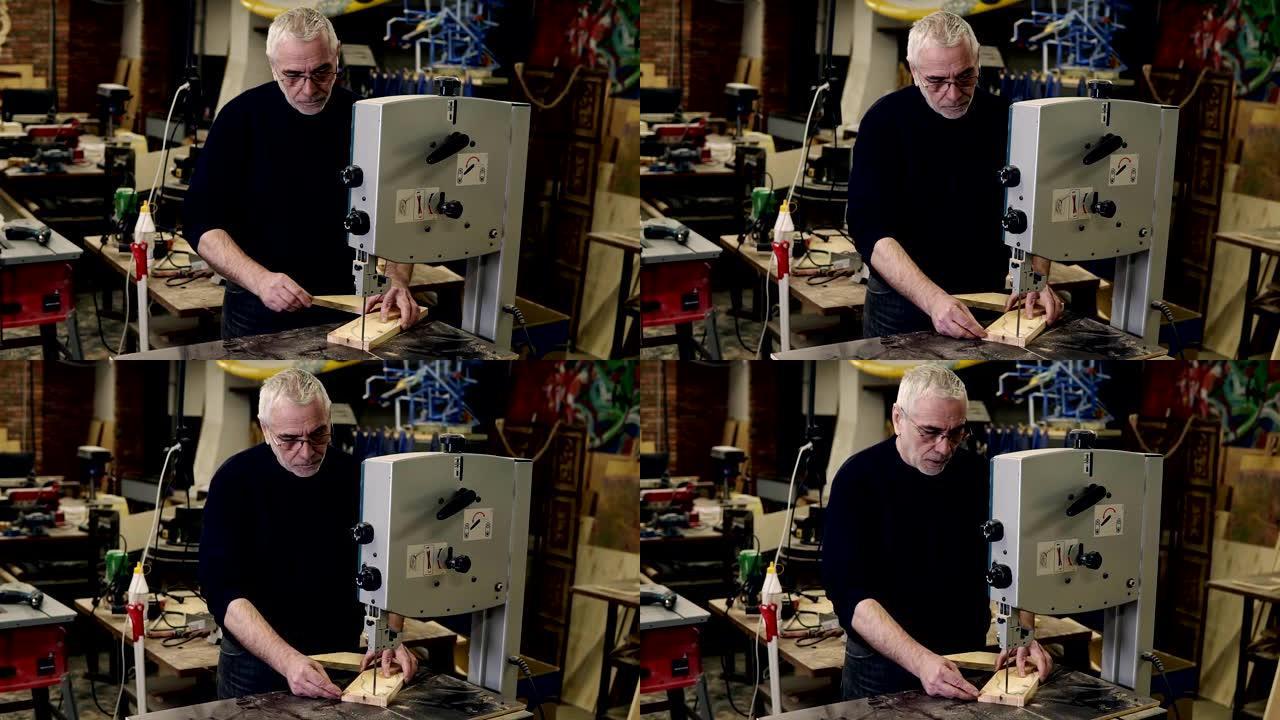 一个成年头发的男人在铣床上工作，同时在车间的一个工作室里雕刻木制图案的肖像。行动。木工行业