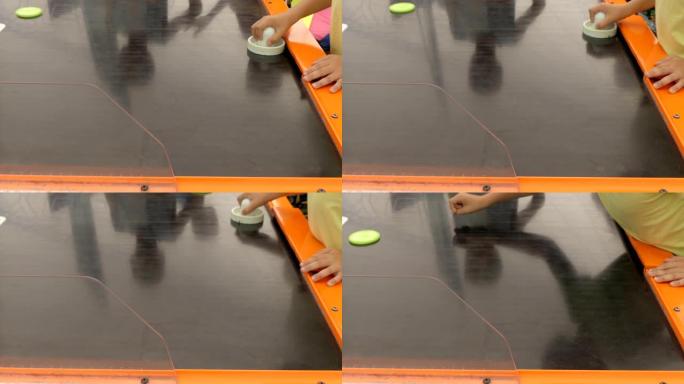 一个孩子玩空中曲棍球特写镜头。游戏桌曲棍球。