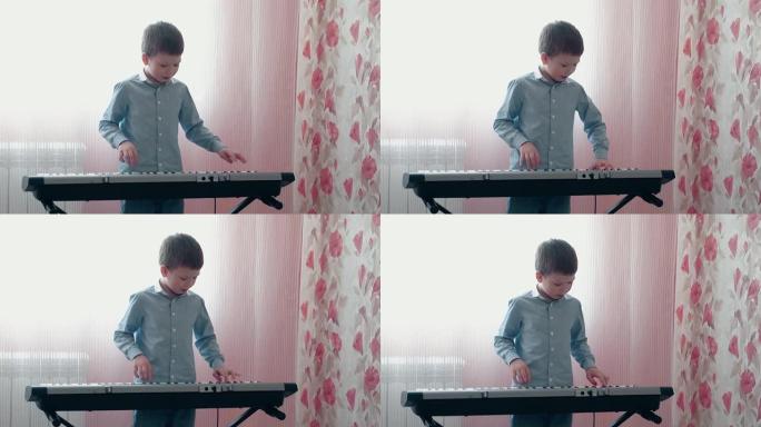 小男孩在音乐合成器上演奏