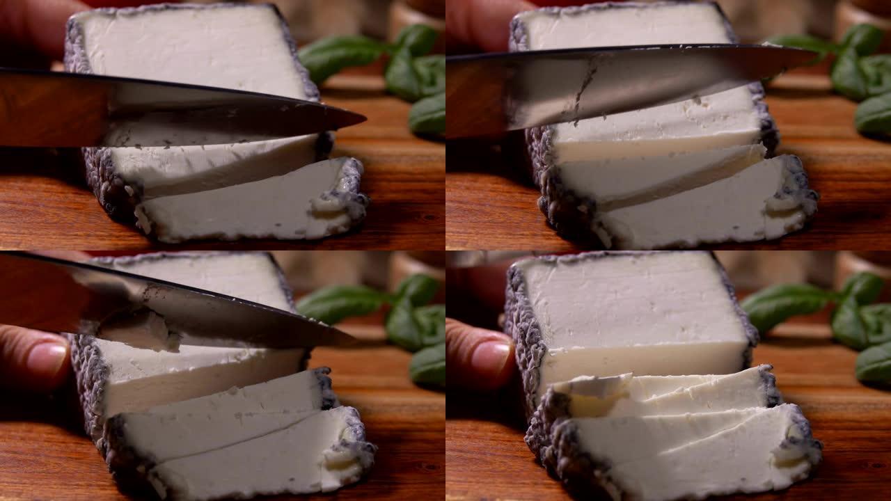 刀在木板上切一块柔软的山羊奶酪
