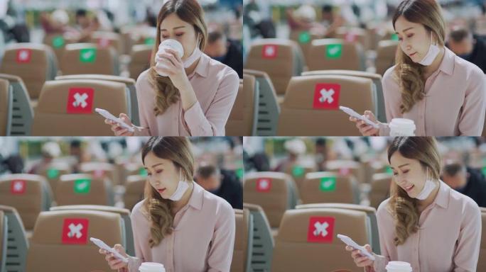 在机场用智能手机喝咖啡的年轻美女