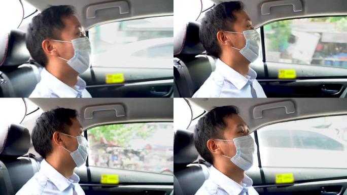 亚洲商人戴着防护口罩坐在出租车后座，在疫情期间，在移动中，商务旅行中，安全