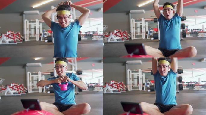 亚洲瘦男人在健身房锻炼时用智能手机看喜剧电影