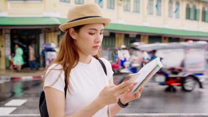 20-30岁的亚洲女性，拿着盘子和智能手机，在附近搜索酒店。泰国旅游局
