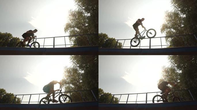 在滑板公园用BMX自行车跳跃的男孩
