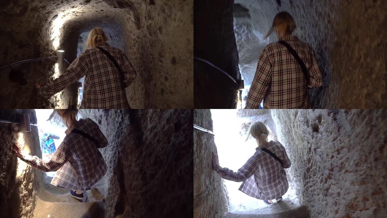 美丽的molassy女游客正走上楼梯前往佐治亚州瓦兹亚的洞穴修道院。女游客去观光