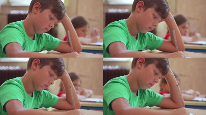 一个专心的小学生正在阅读他的教育考试并思考正确的答案