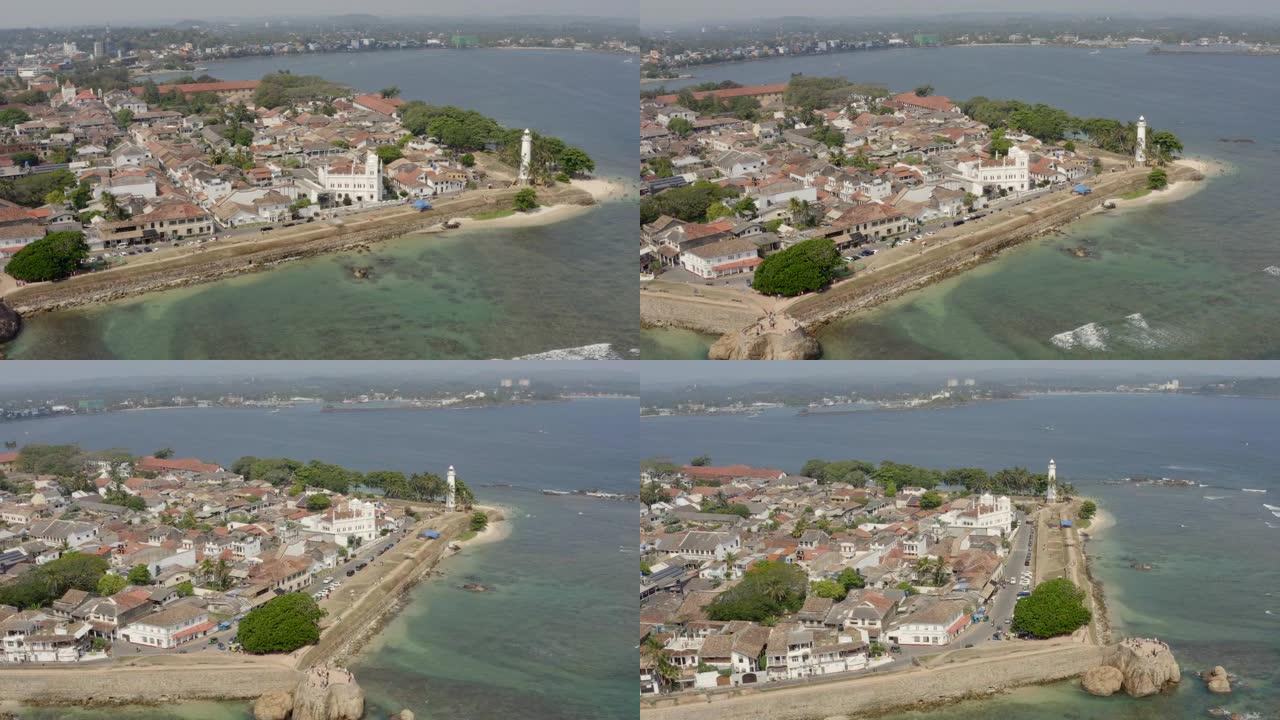 无人机拍摄的斯里兰卡加勒镇和灯塔。加勒是一个封闭在该国南部海岸堡垒墙中的殖民城镇。鸟瞰图公路角度