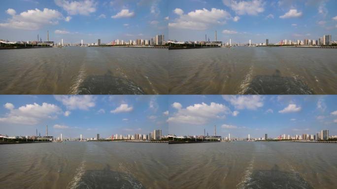 在黄浦江上航行的船只，大型船只后面的水尾迹与黄浦江上的上海城市地标相结合。慢动作4k镜头。