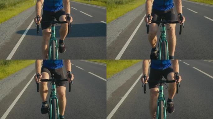 自行车手在方向盘上的特写镜头。他猛踩刹车，踩踏板。骑自行车训练。4K