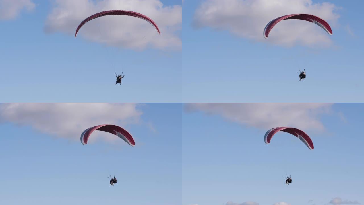 两个人飞行滑翔伞。极端滑翔伞在湛蓝的天空中飞翔。滑翔伞串联。极限运动。