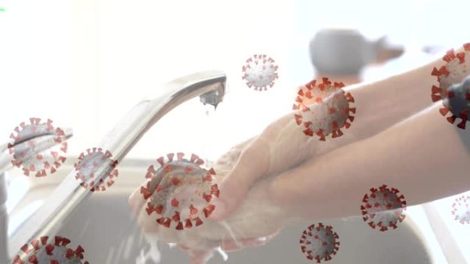 冠状病毒细胞散布在正在清洗的手上。