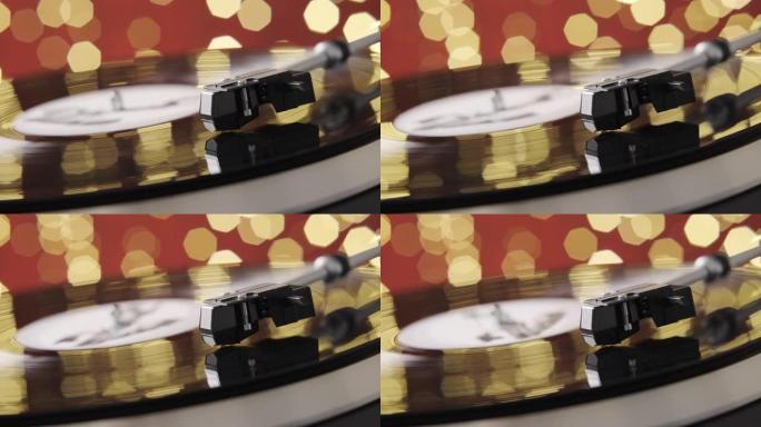 旋转黑色转盘乙烯基唱片红色背景bokeh圣诞灯晚会。平板上的触控针特写。DJ的声音技术。70年代、8
