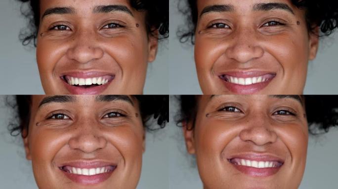 年轻的黑人女性微距特写脸看着相机微笑
