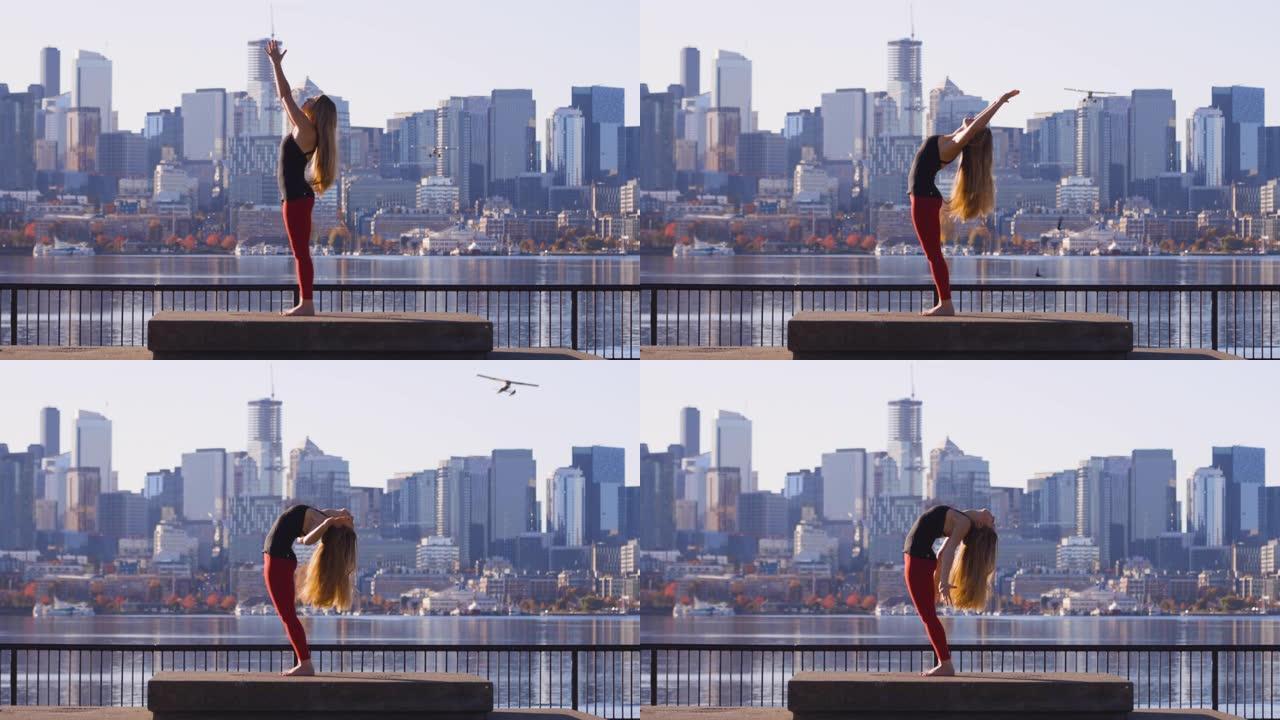 惊人的瑜伽射击女孩后弯伸展鸟类和飞机在西雅图华盛顿州天际线前飞行