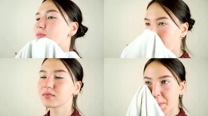 年轻漂亮的女人用洗泡沫洗脸。