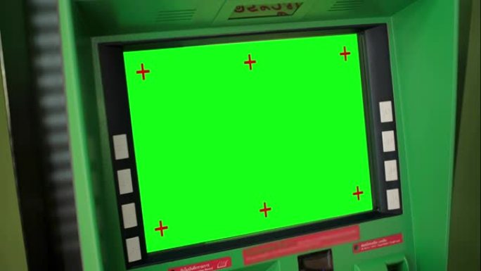 自动取款机，绿屏闪烁绿色信号。特写。